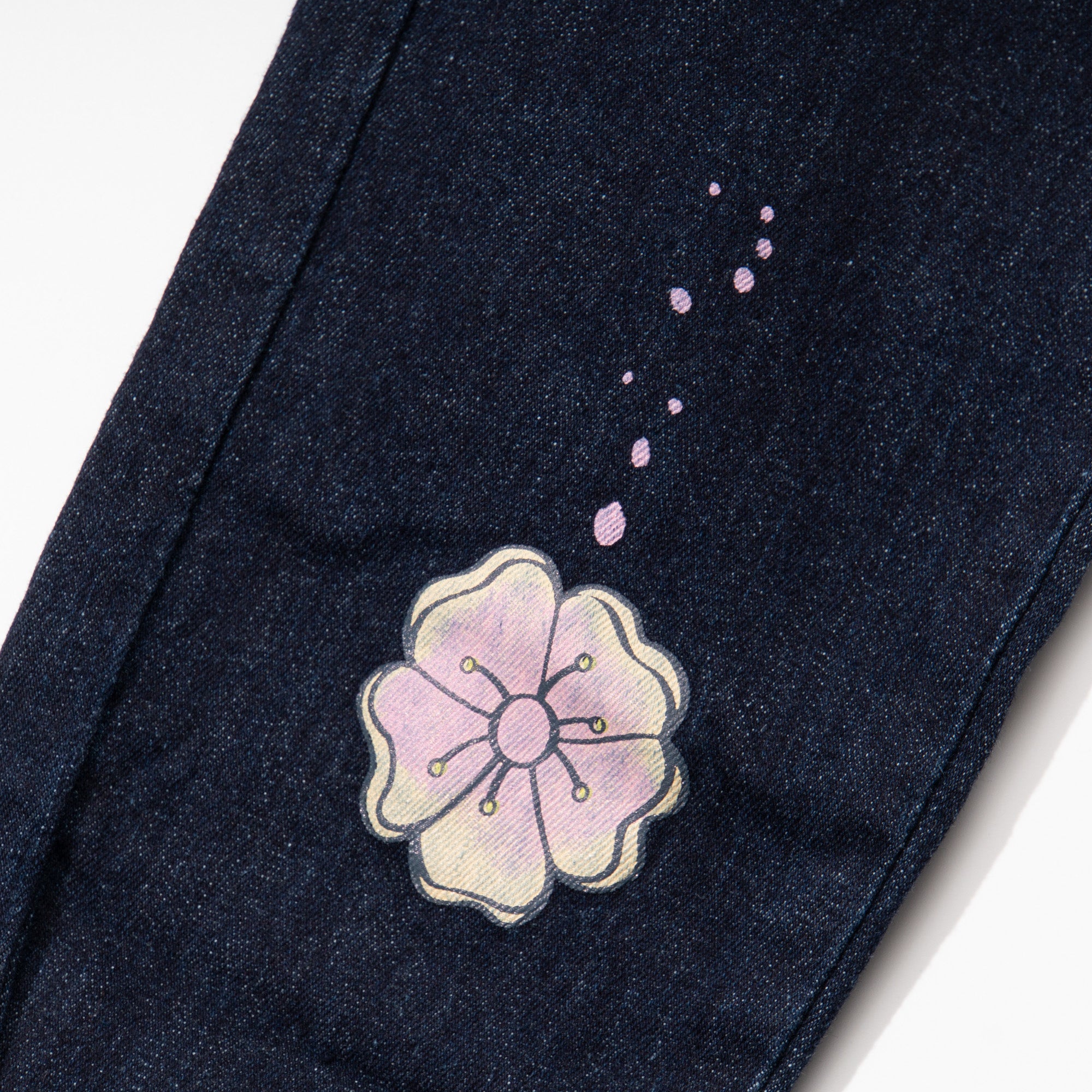 Indigo black jeans for girls, floral embossed prints above the hem and below the waist. A denim ribbon tie on waistband. Two front pockets included.Elasticated.  