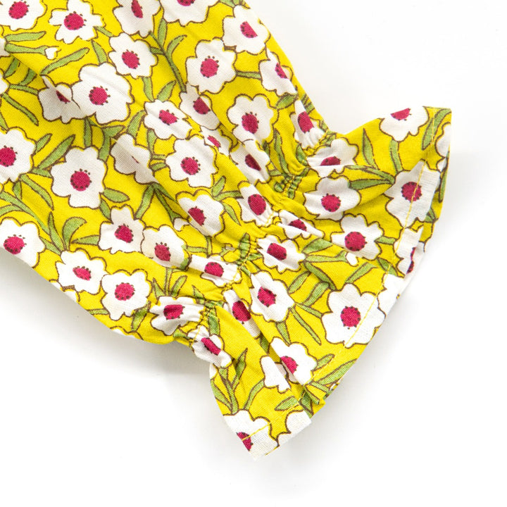 Yellow floral blouses, ruffled sleeves, a ribbon and a ruffled waist. Button fastenings included. 