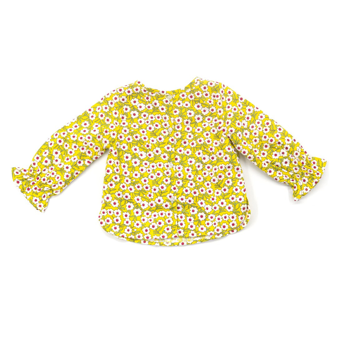 Yellow floral blouses, ruffled sleeves, a ribbon and a ruffled waist. Button fastenings included. 