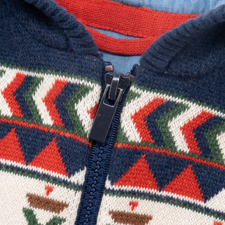 Red, whites and green on a navy woven, tribal jacket with a hoodie. knitted tribal patterns on Upper yoke.  front fastening of a zipper, rib-knit cuffs and hem. 