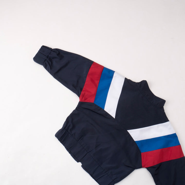 Blue, white and red patched block jacket, high collar, front zipper fastening. Two pockets, Poney Logo tag attached. 