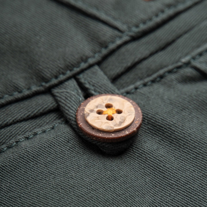 Pine green straight trousers, front pockets, buttoned pockets. Poney logo attached at the back. 