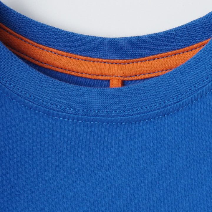 Blue short sleeve top, double button fastening, distinctive inner finish. 'Ive got the power' caption emboss printed.