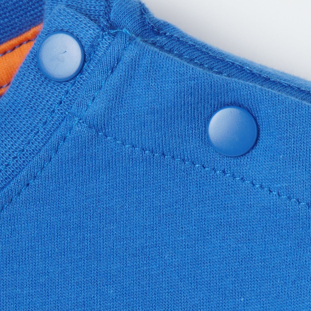 Blue short sleeve top, double button fastening, distinctive inner finish. 'Ive got the power' caption emboss printed.