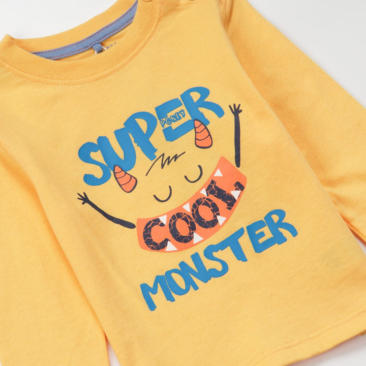 'Super Cool Monster' printed, yellow top, long sleeves, shoulder buttons. 