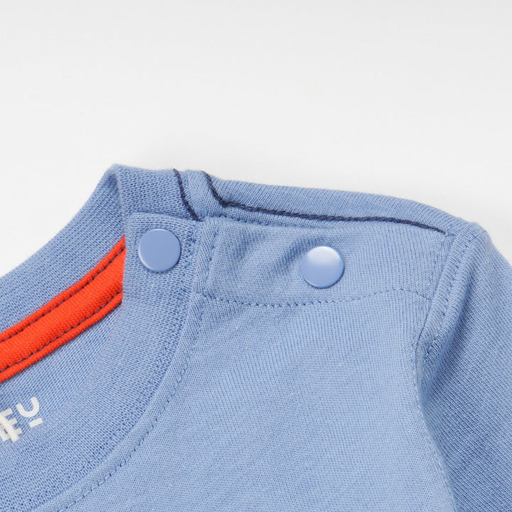 Full- sleeve blue top, poney embossed boxed design, double snap buttons for neck adjustment.  Edit alt text