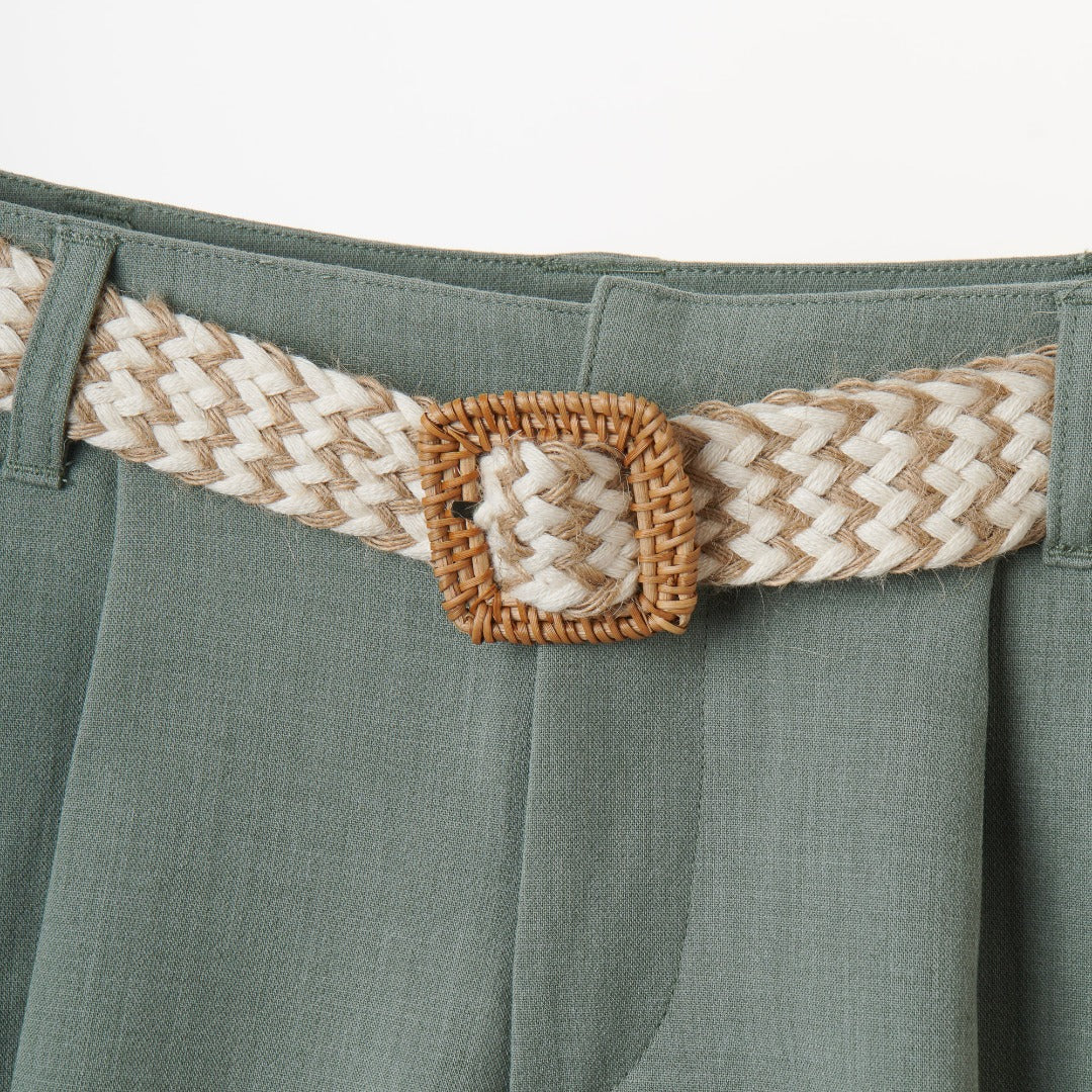 Green Pleated girl's short, front zipper, hook and bar fastening .A cream knitted belt included, adjustment button inside the waist band. 