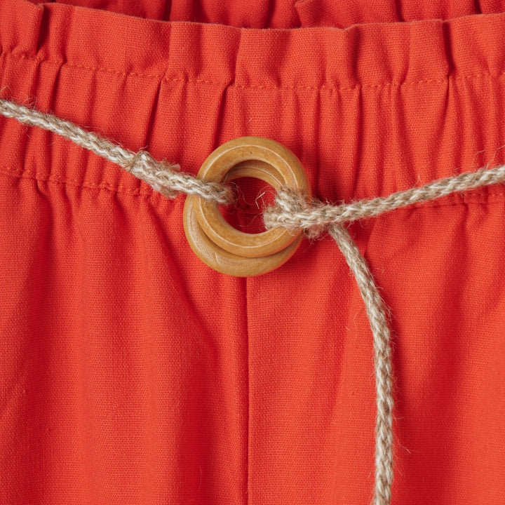 Beautifully cut, red palazzos, elasticated waist band, a delicate khaki waist belt, Two side pockets included. 