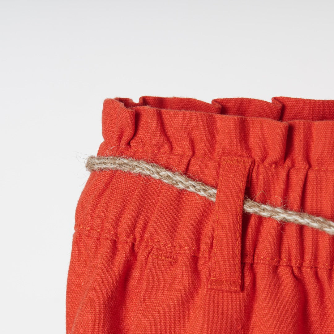 Beautifully cut, red palazzos, elasticated waist band, a delicate khaki waist belt, Two side pockets included. 