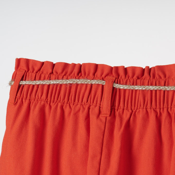 Beautifully cut, red palazzos, elasticated waist band, a delicate khaki waist belt, Two side pockets included. 