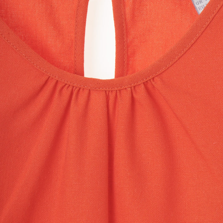 Red sleeveless Dress Long upper rounded bodice attached with a loose frilly lower skirt V-neck with a buttoned nape at the back.