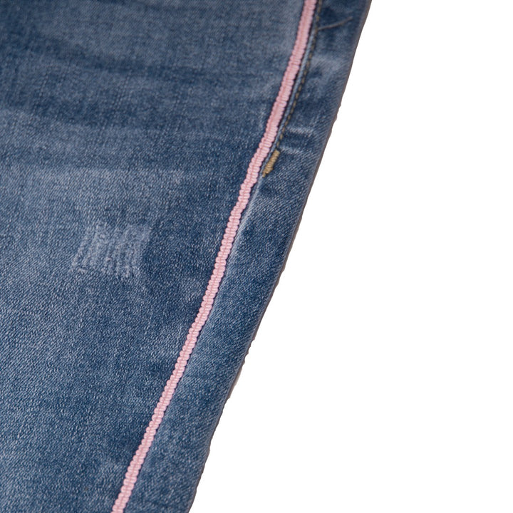 Royal Blue Jeans, Pink Stripes on each side, distressed and faded effect, front and back pockets embroidered, a pink logo button and zipper included.