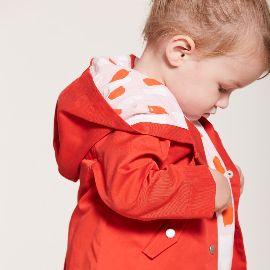 Orange Cotton Jacket, Lined by next-to-skin fabric , two Front pockets, front lining fastened by snap buttons, heart shaped logo embroidered at the front. 