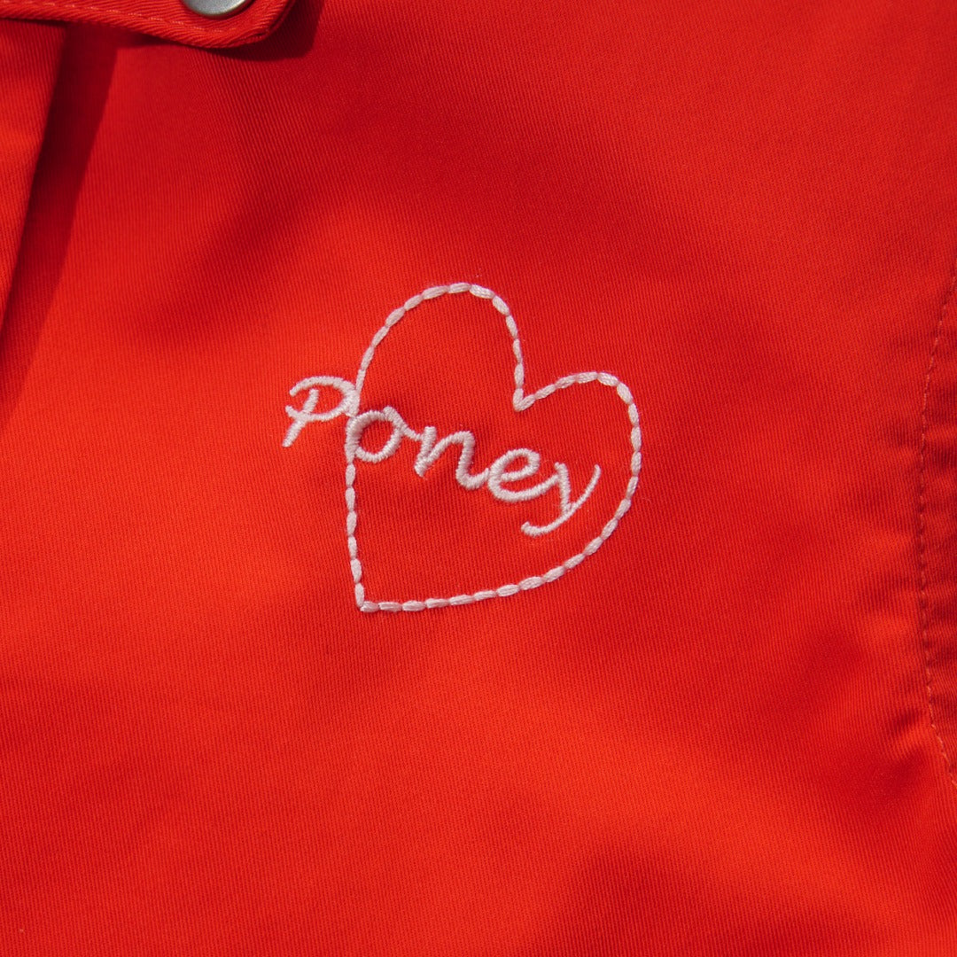 Orange Cotton Jacket, Lined by next-to-skin fabric , two Front pockets, front lining fastened by snap buttons, heart shaped logo embroidered at the front.