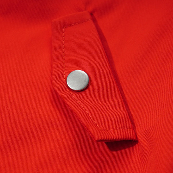 Orange Cotton Jacket, Lined by next-to-skin fabric , two Front pockets, front lining fastened by snap buttons, heart shaped logo embroidered at the front.