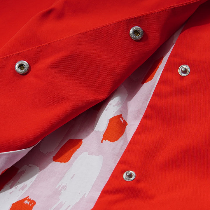 Orange Cotton Jacket, Lined by next-to-skin fabric , two Front pockets, front lining fastened by snap buttons, heart shaped logo embroidered at the front.